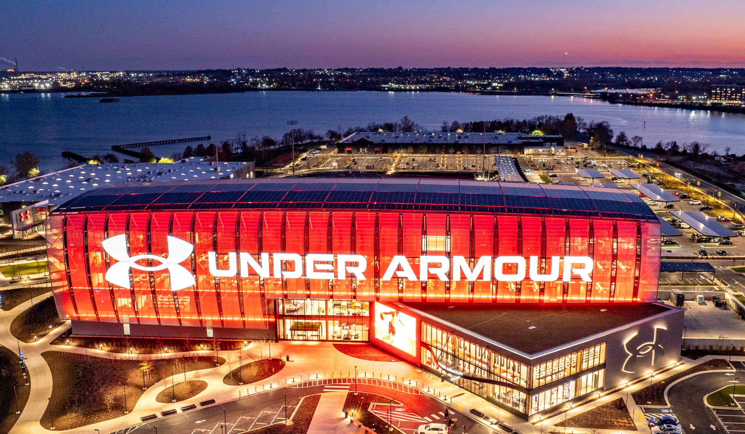 Under Armour global headquarters in Baltimore, lit red at dusk